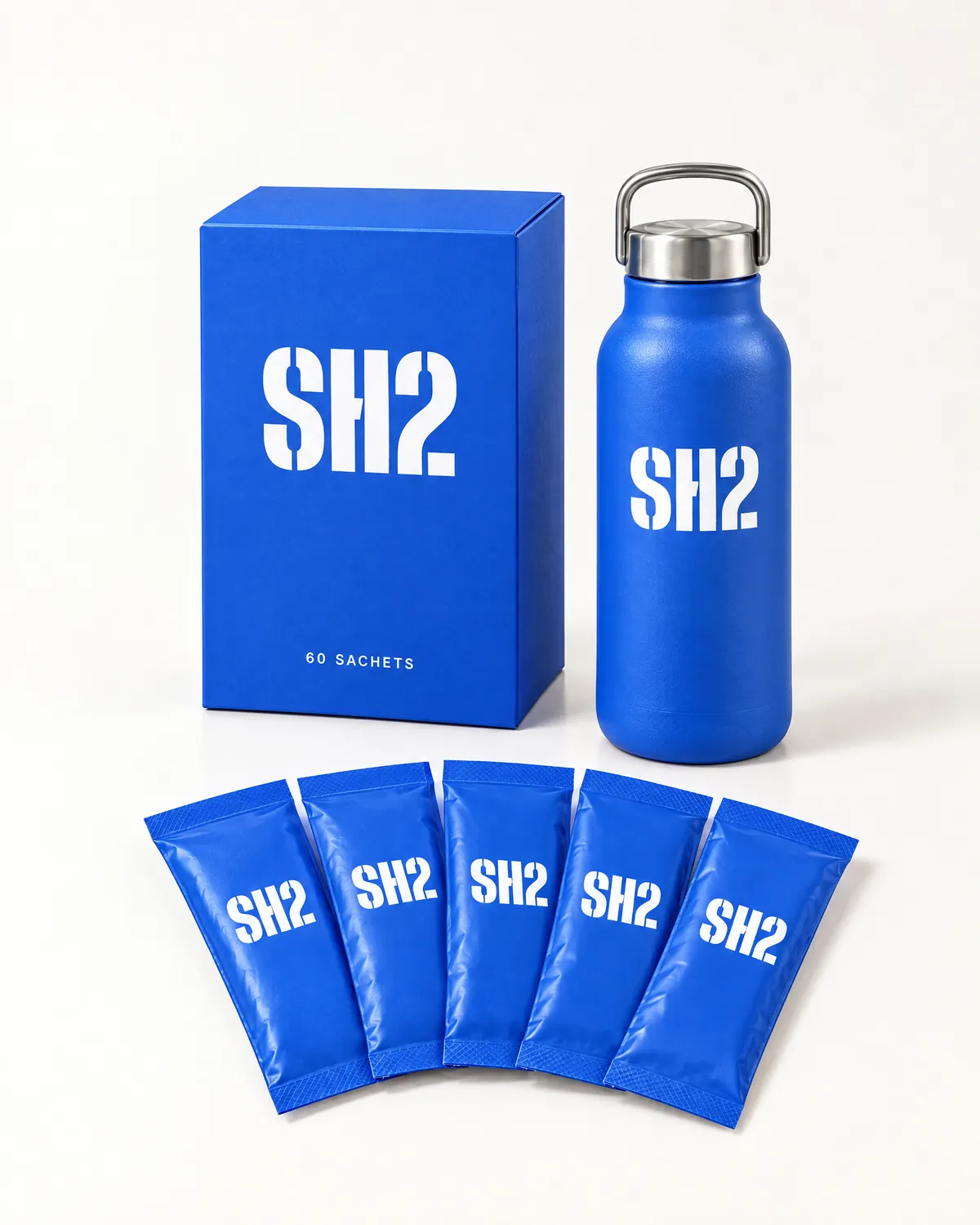 The SH2 box, the steel bottle and five sachets laid out on white